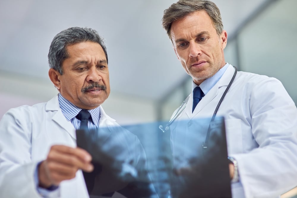 Orthopedic doctors, hospital and x ray team, diagnose and discussion with communication. Surgeons, collaboration and healthcare for patient, medicine and professional speak for picture medical advice
