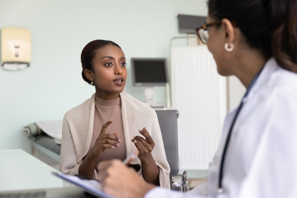 Young patient woman consulting doctor in clinic, showing patient engagment and why it is important